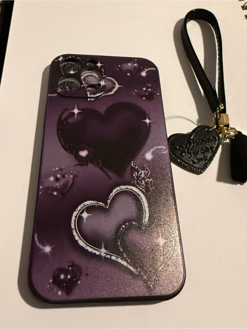 Purple Heart Pattern Phone Case with Wrist Strap for Apple 16 pro max.